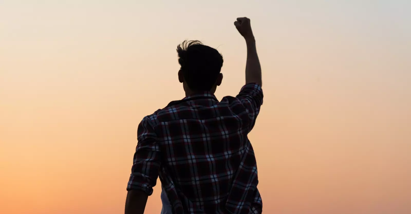 man-with-fist-pump-in-air-in-victory-through-god