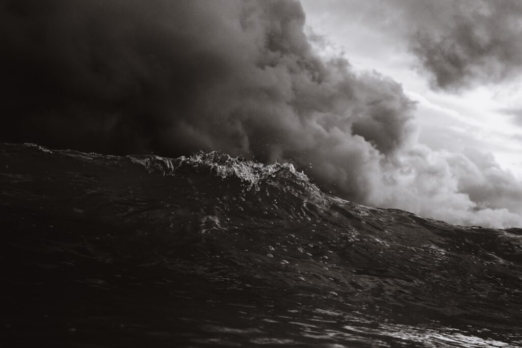 Dark turbulent ocean waves under a stormy sky.