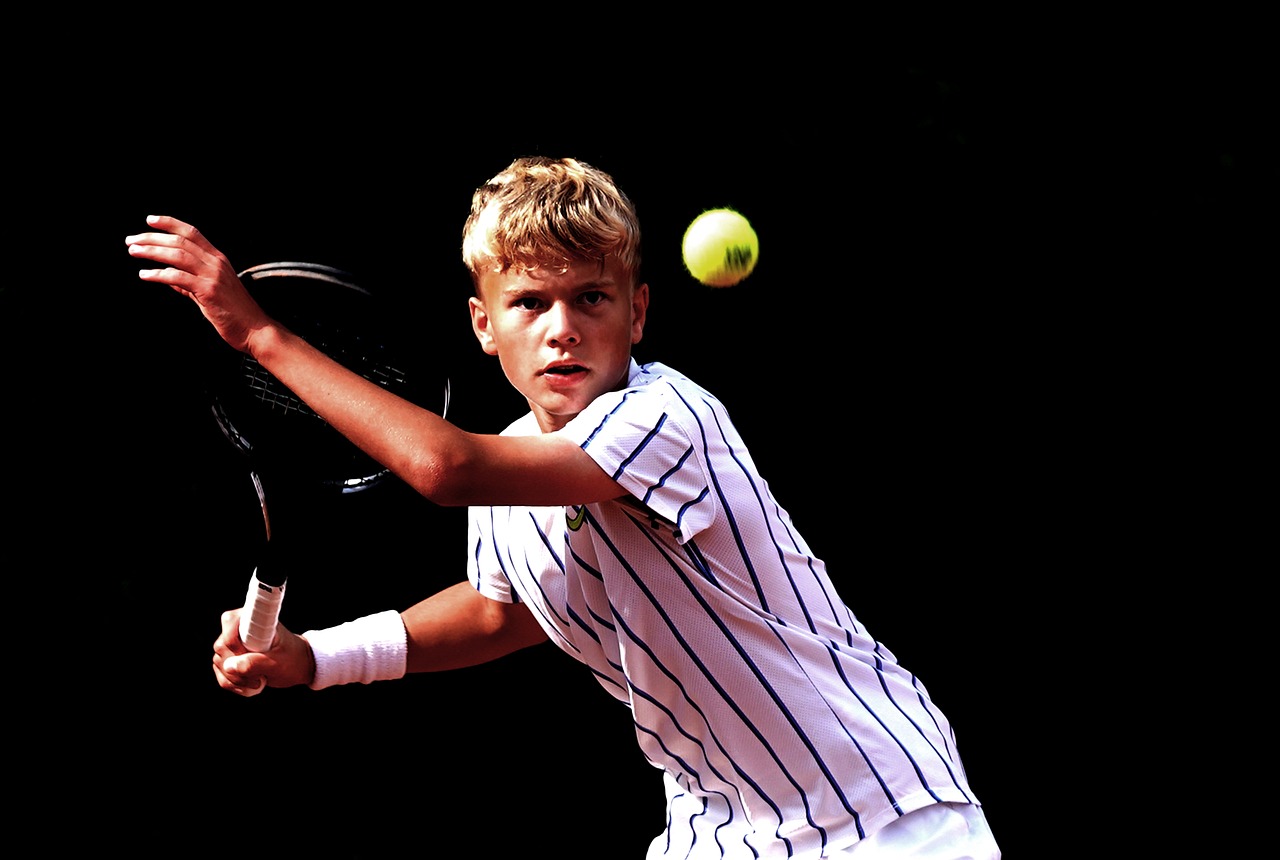Young male tennis player preparing to hit a ball during a match.