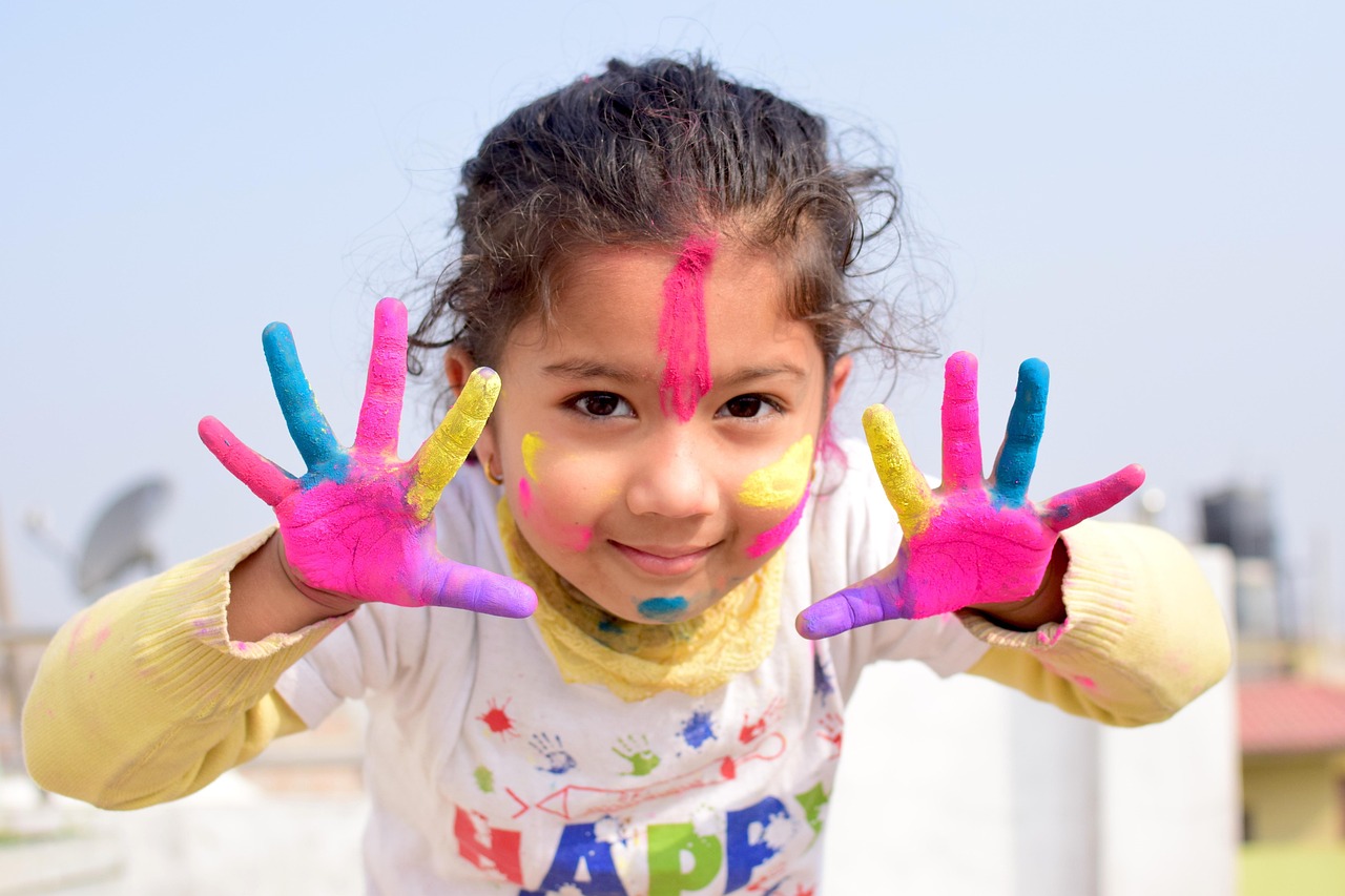girl-prosperity-happy Happy smiling young girl with finger paints